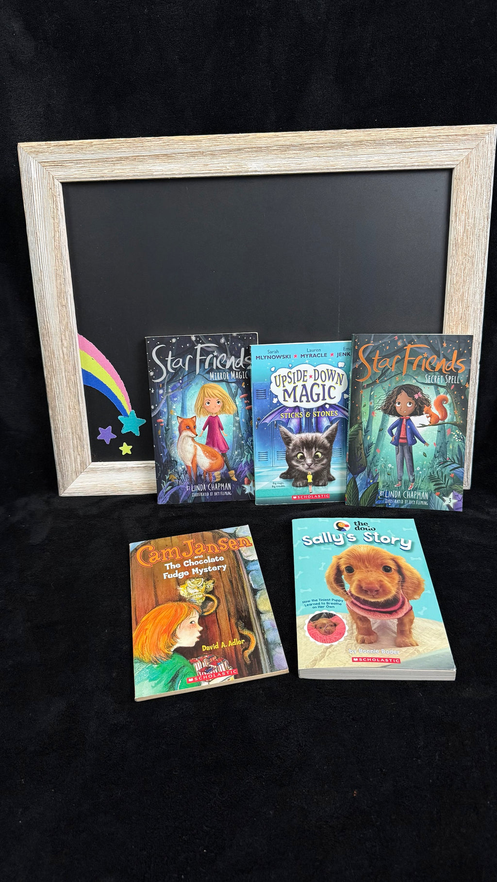 Rainbow Joy Book Shop Blue bundle flat lay with chalkboard rainbow prop