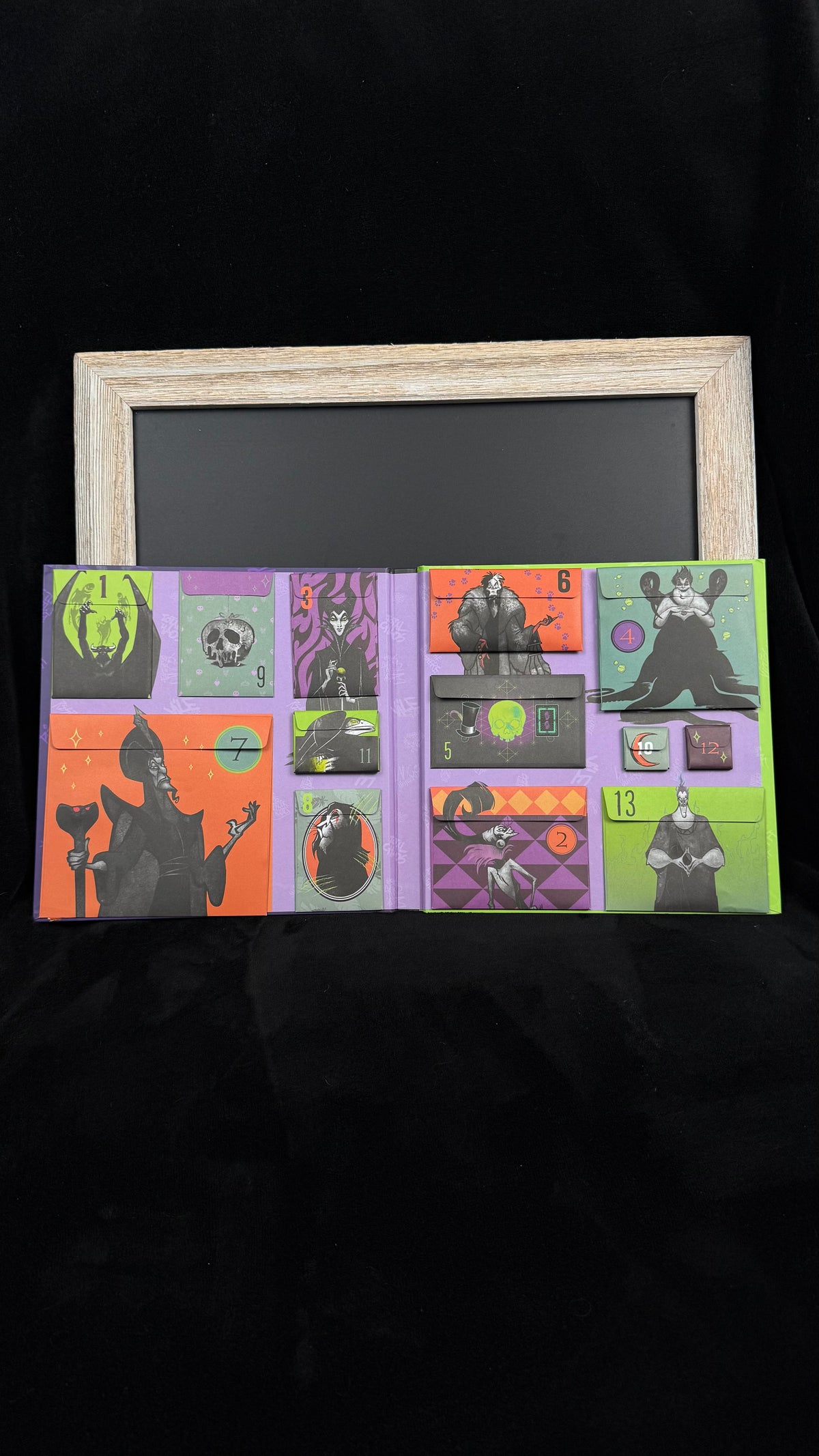 Inside the Disney Villains countdown calendar showing all 13 numbered envelope pockets, sealed