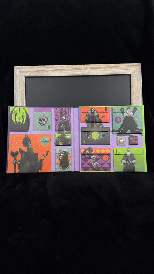 Inside the Disney Villains countdown calendar showing all 13 numbered envelope pockets, sealed