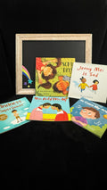 Social Emotional book bundle flat lay with chalkboard rainbow prop, five picture books about feelings