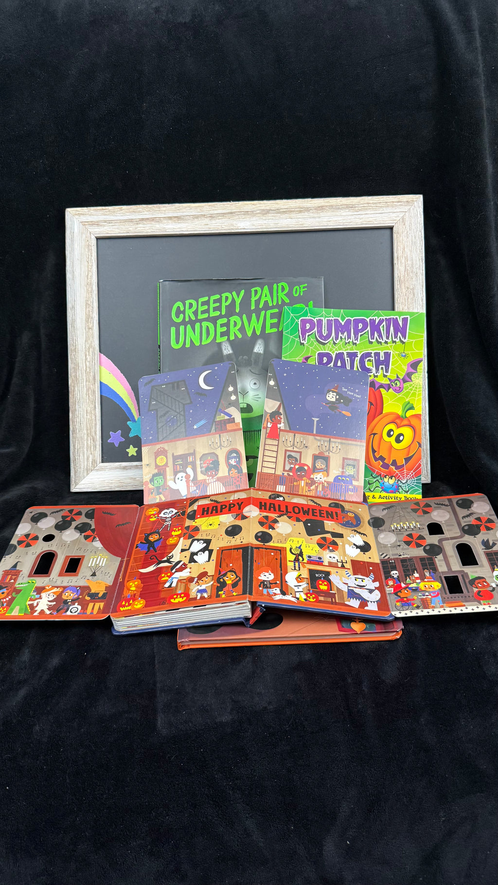 Spookytale board book opened to show its gatefold Happy Halloween party spread