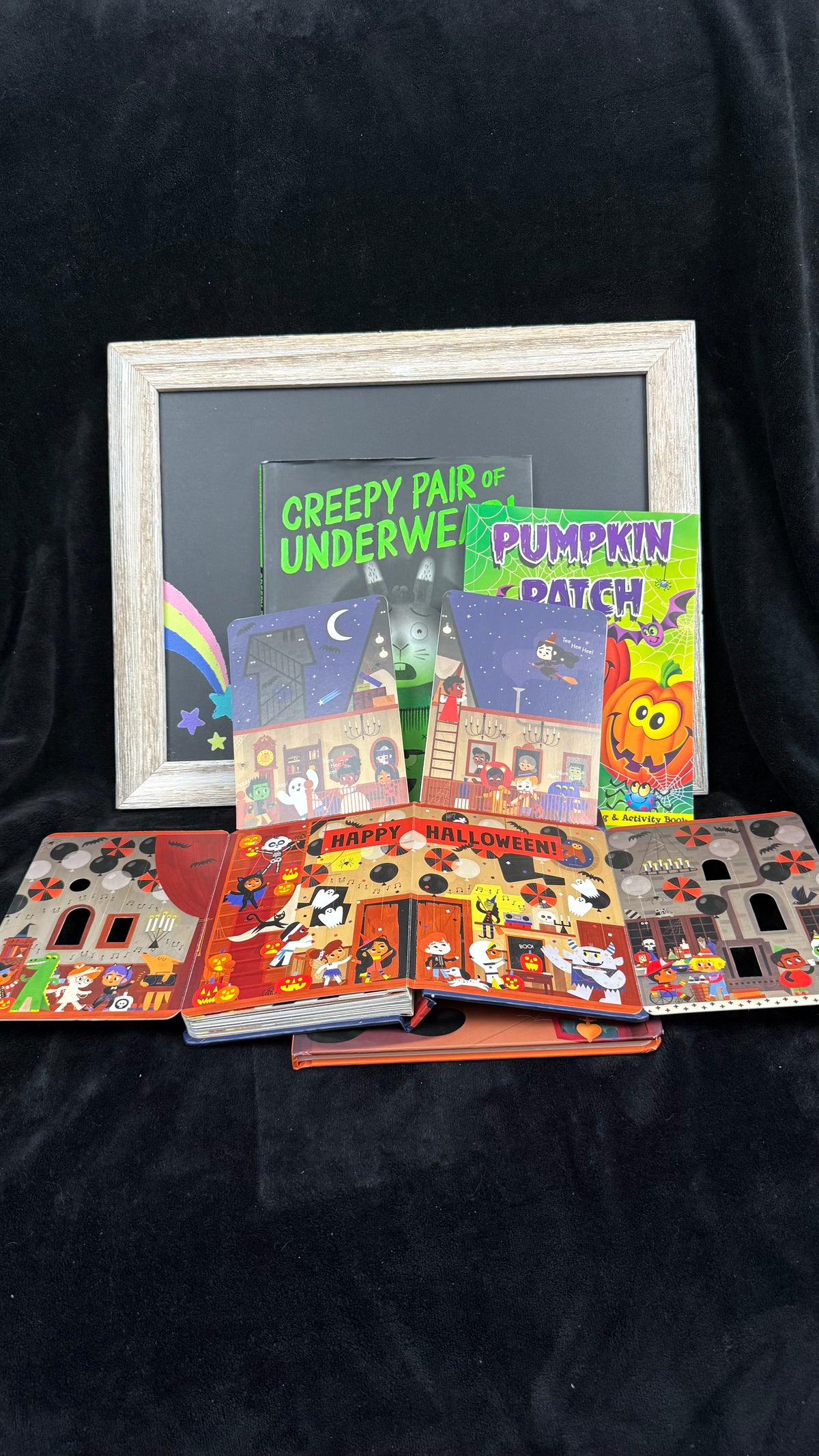 Spookytale board book opened to show its gatefold Happy Halloween party spread